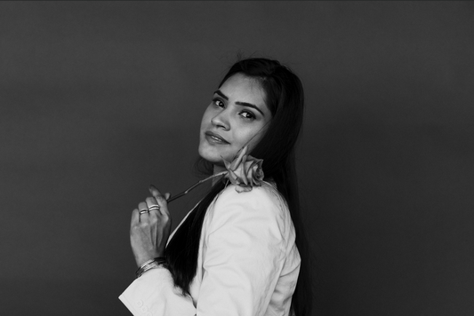 Black and white image of woman holding a single rose